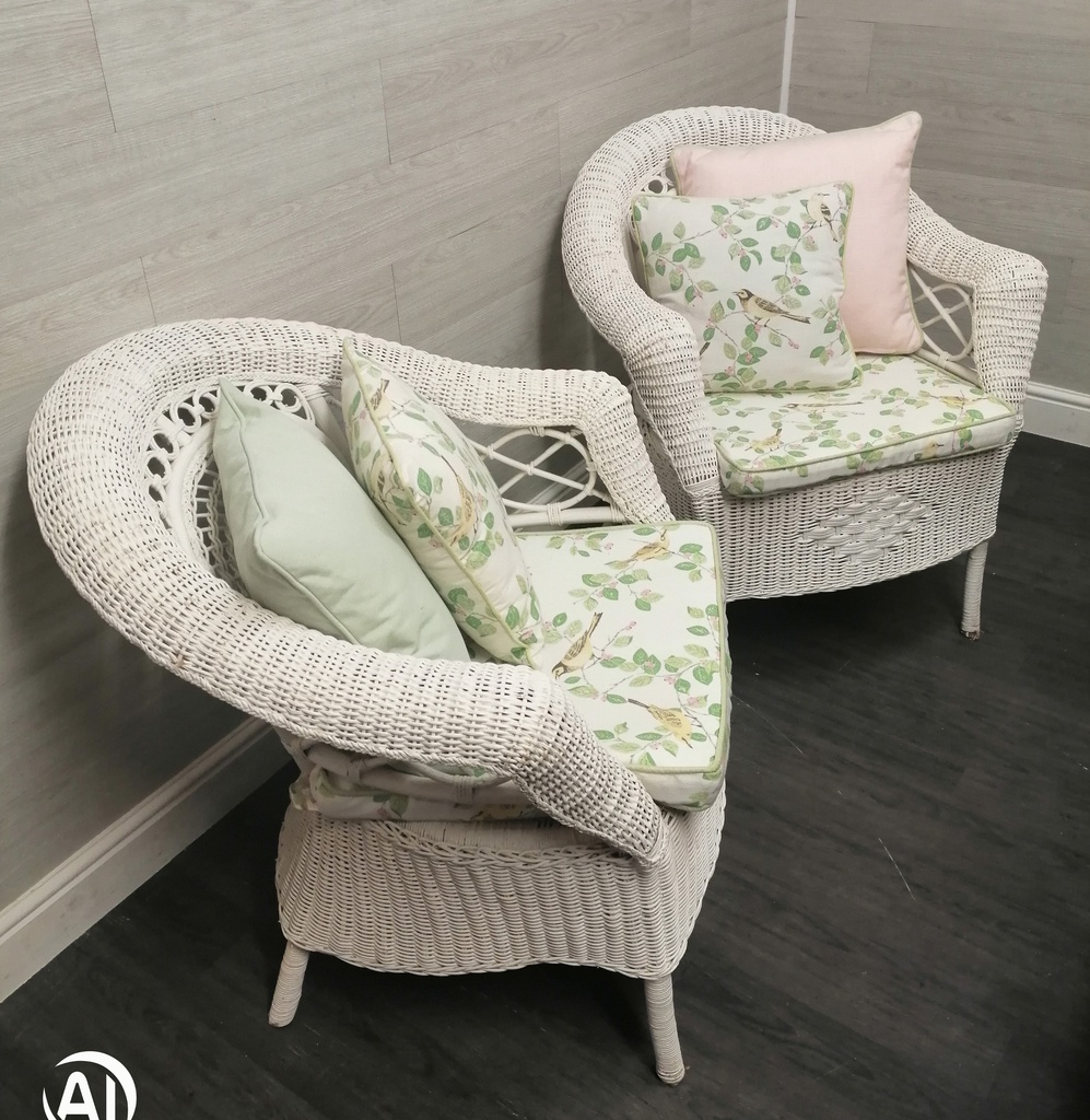 lovely cushioned white wicker armchair